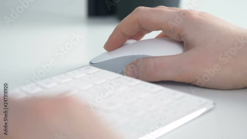Woman hand click pc white mouse in home office on white table. Close up 4k business footage.