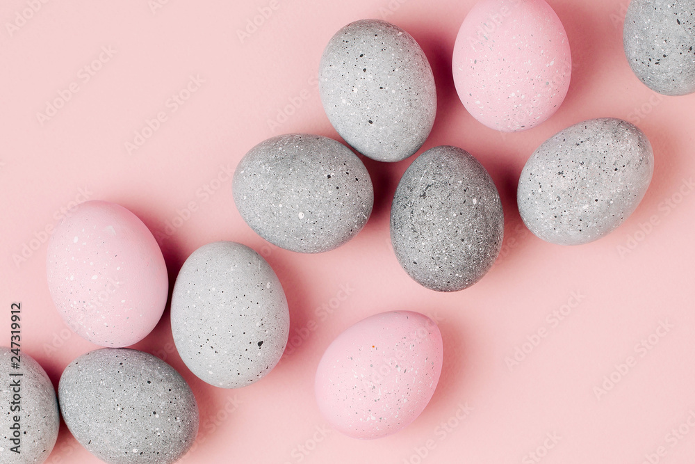 Stylish background of pale pink and gray Easter eggs. Dyed Easter eggs. Flat lay Stylish background of pale pink and gray Easter eggs. Dyed Easter eggs. Flat lay