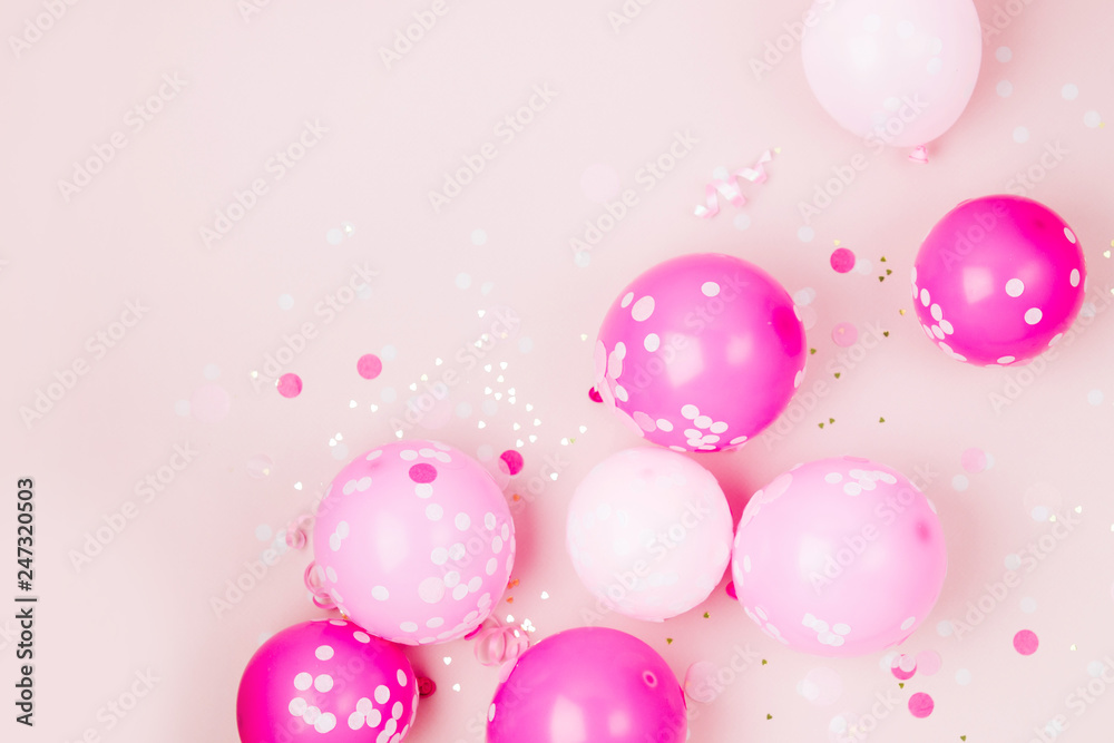 Pink balloons  with Confetti, bows and paper decorations. Birthday party concept theme. Flat lay, top view