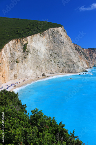Porto Katsiki beach on the Ionian island of Lefkada, Greece. People sunbathe and enjoy on vacation. The beach is famed for its landscape and clear blue sea