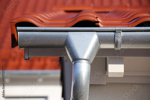Roof gutter on a new tiled roof photo