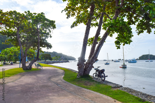 Street in Santa Barbara de Samana in front of the ocean with many boats, dominican repulic photo