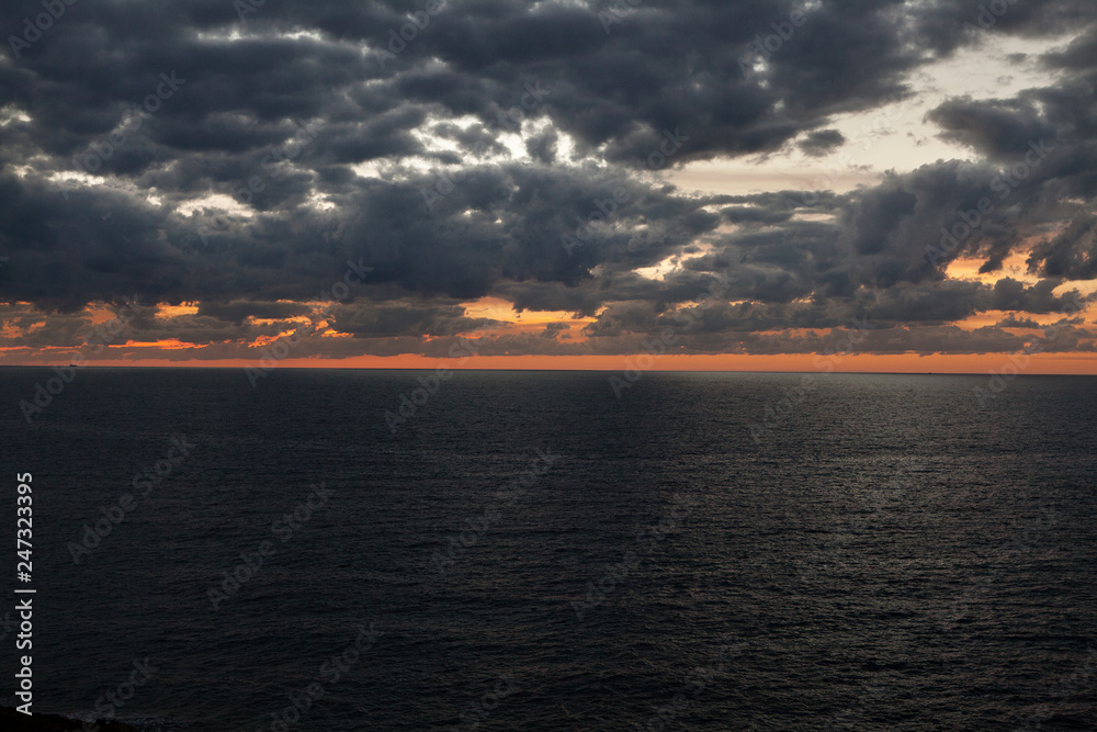 Fototapeta premium Sunset over the sea near the Gozo island, Malta. - Image