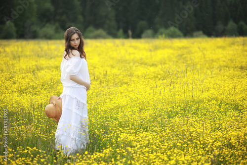 Pregnant woman in a dress in a field of flowers © alexkich