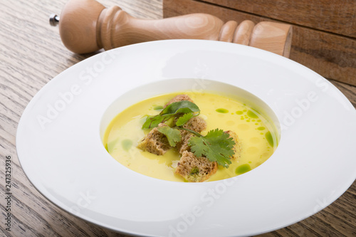 Yellow cream soup served with croutons