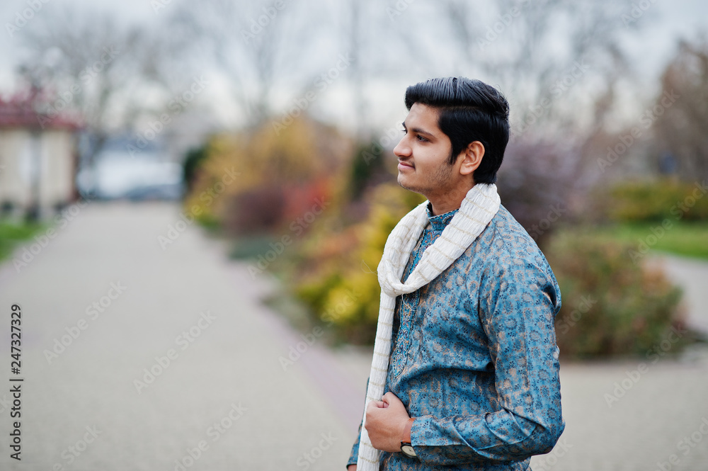 Indian man wear on traditional clothes with white scarf posed outdoor.