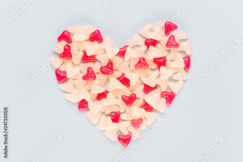 Valentines day background pastel hearts on blue wooden background.