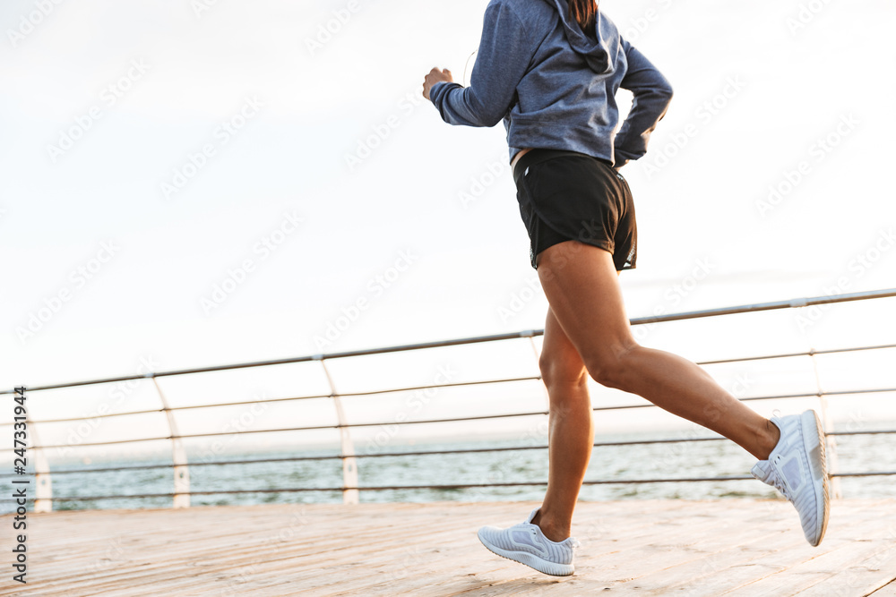 Young sports fitness woman running at the beach outdoors. Young sports fitness woman running at the beach outdoors.