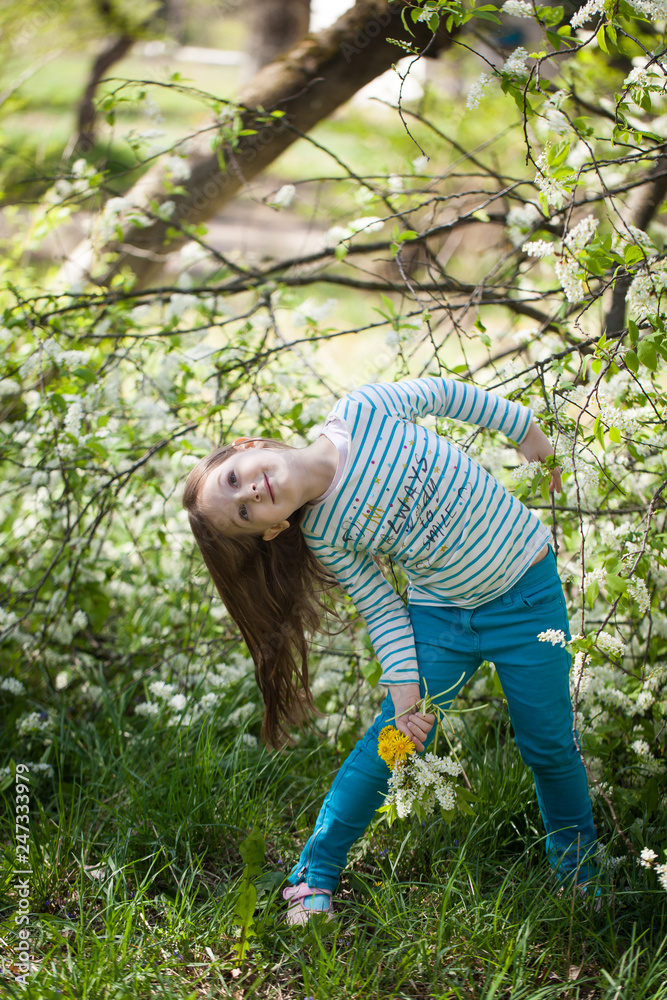 Cute girl in blooming bird cherry tree garden Cute girl in blooming bird cherry tree garden