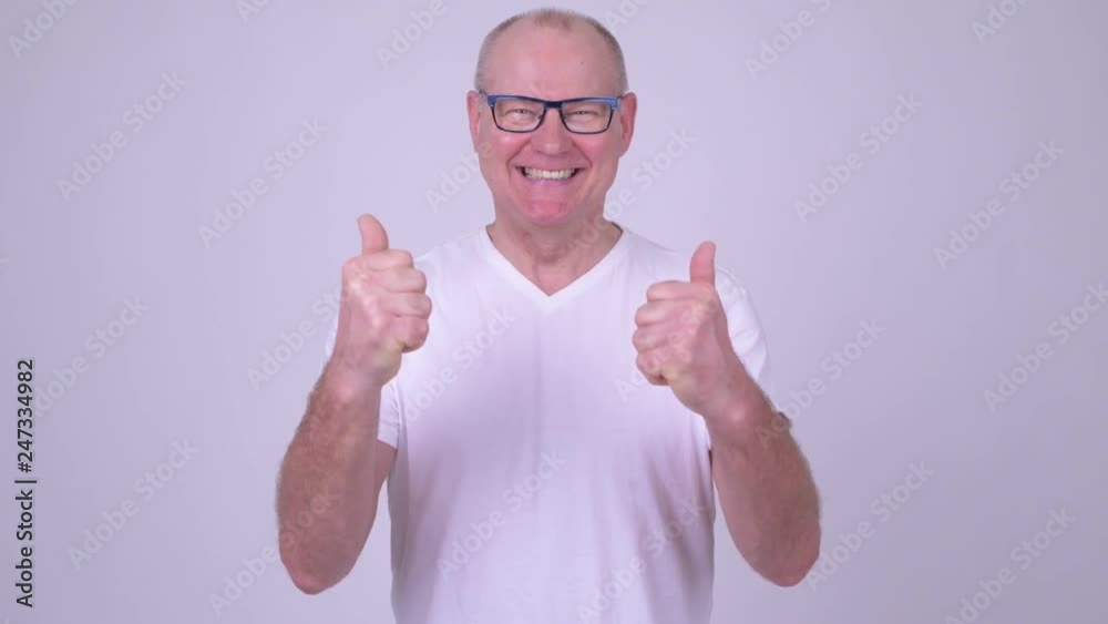 Happy handsome senior man giving thumbs up and looking excited Happy handsome senior man giving thumbs up and looking excited