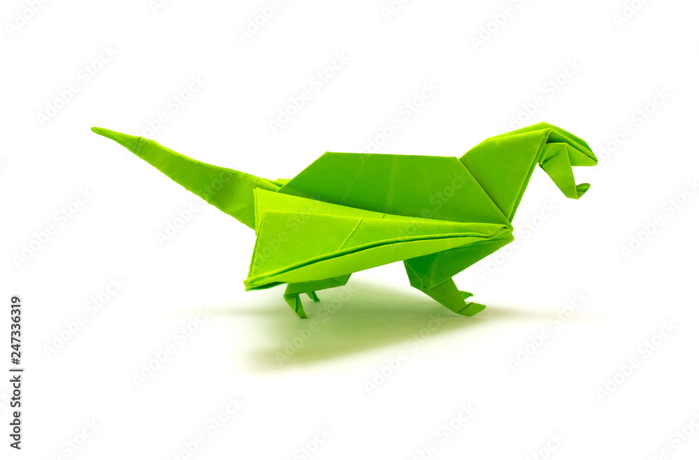 Photo of origami green dragon isolated on white background Photo of origami green dragon isolated on white background