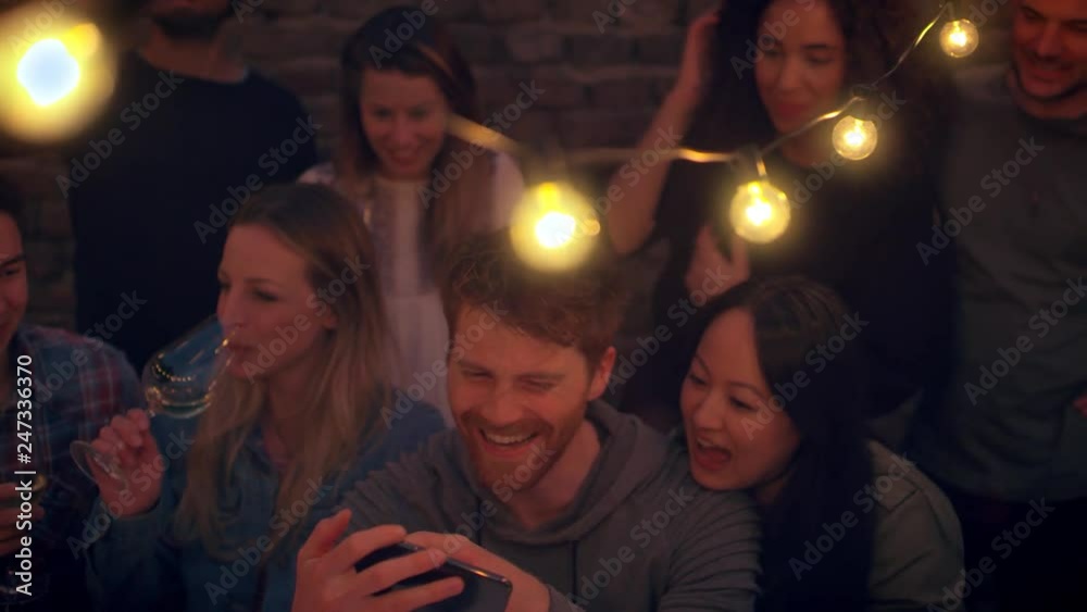 Friends looking at a picture at night Friends looking at a picture at night