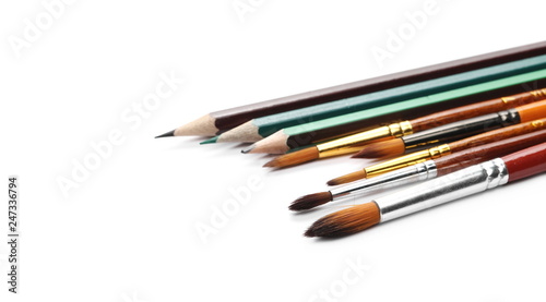 Paintbrushes and pencils isolated on white background