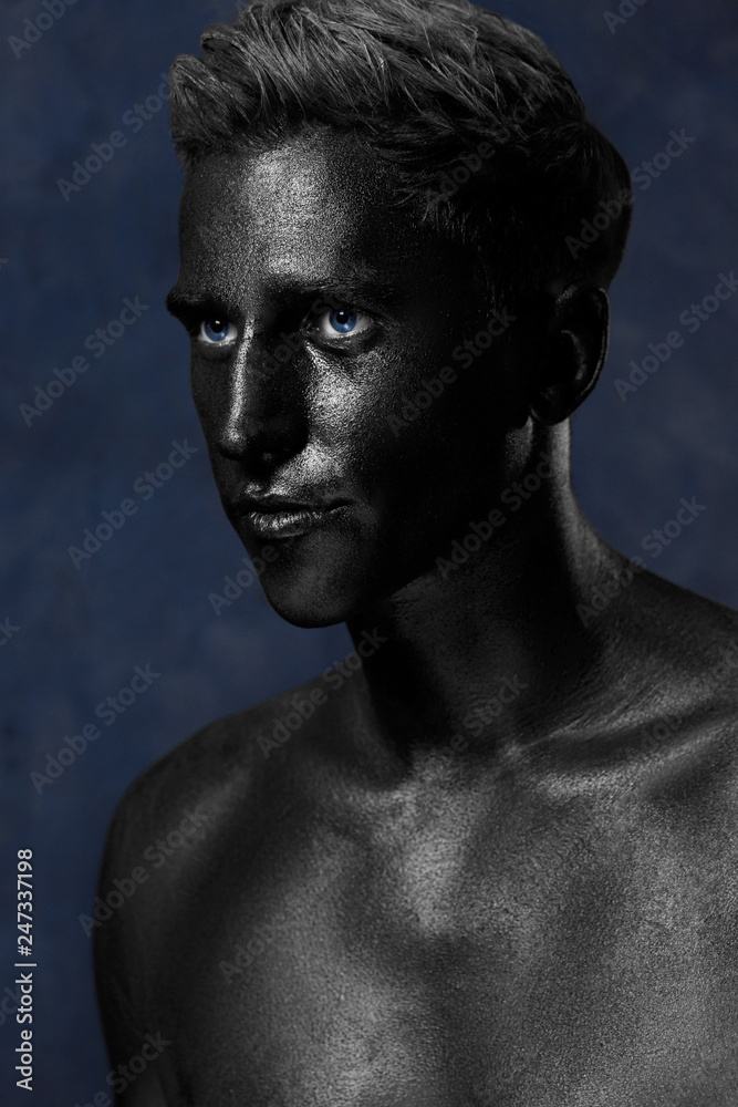 a man in black make-up. portrait in dark paint. Art photography portrait a man in black make-up. portrait in dark paint. Art photography portrait