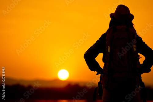 Female tourists with backpacks Traveling at sunset 