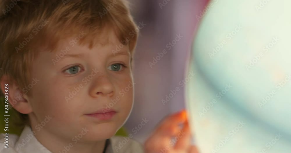 Portrait Of Young Blonde Boy While Exploring Globe Portrait Of Young Blonde Boy While Exploring Globe