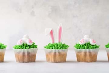Homemade Easter cupcakes in a row. Funny dessert for children.