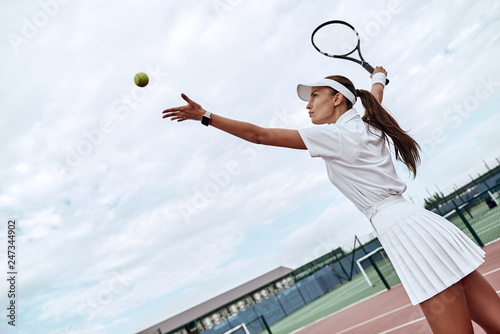 Develop your skills. Attractive sportswoman throws the ball into the air © Friends Stock