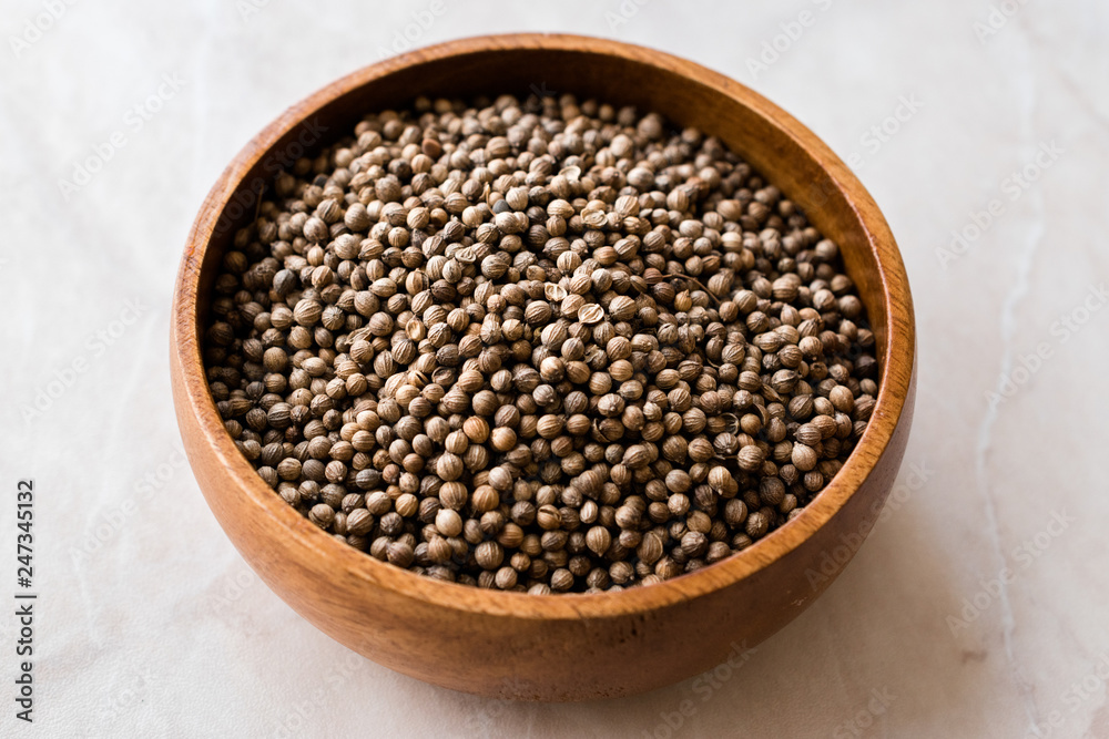 Organic Dried Coriander Seeds in Wooden Bowl. Organic Dried Coriander Seeds in Wooden Bowl.