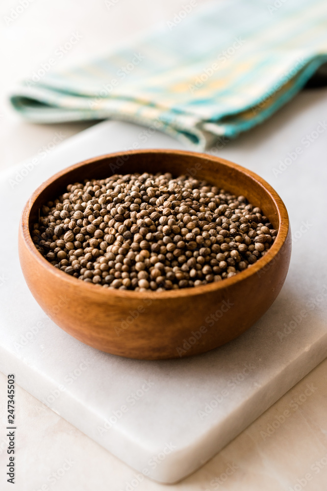 Organic Dried Coriander Seeds in Wooden Bowl. Organic Dried Coriander Seeds in Wooden Bowl.