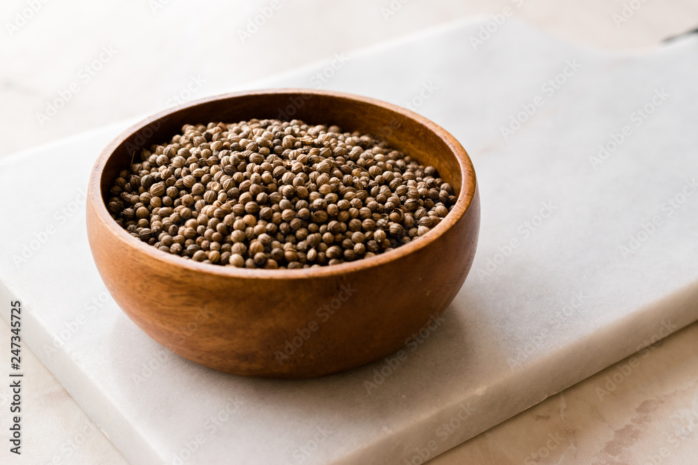 Organic Dried Coriander Seeds in Wooden Bowl. Organic Dried Coriander Seeds in Wooden Bowl.