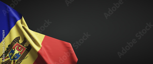 Moldova flag fabric on plain dark background photo