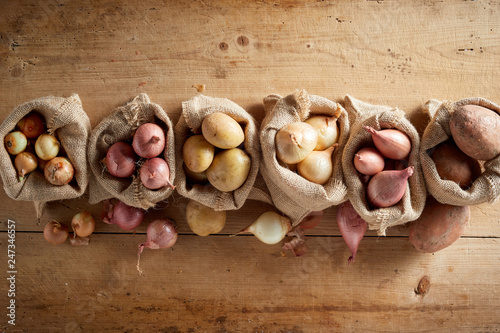 Assortment of onions and potatoes in sack bags photo