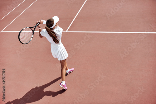 Waiting for the return. Young woman play tennis © Friends Stock
