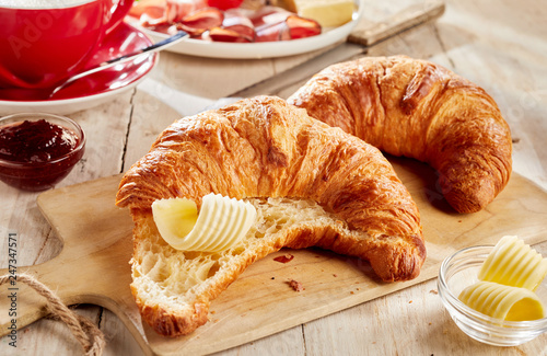 Obraz na płótnie Sliced croissant served with butter