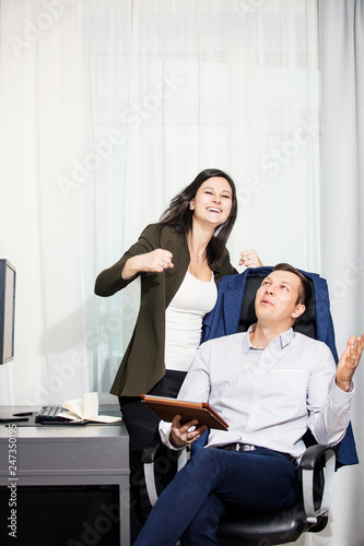Young adult male and female businessmen at their Desk with a computer in the office during working hours