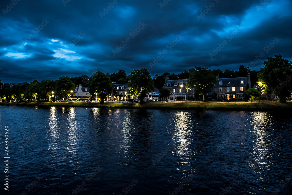 Illuminated Buildings In The Scenic Streets Of The City Of Inverness At The River Ness At Night in Scotland