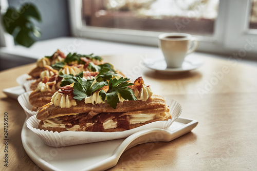 Tasty eclairs on wooden table, close up