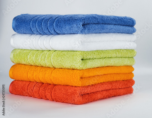 Multicolored towels on a white background photo