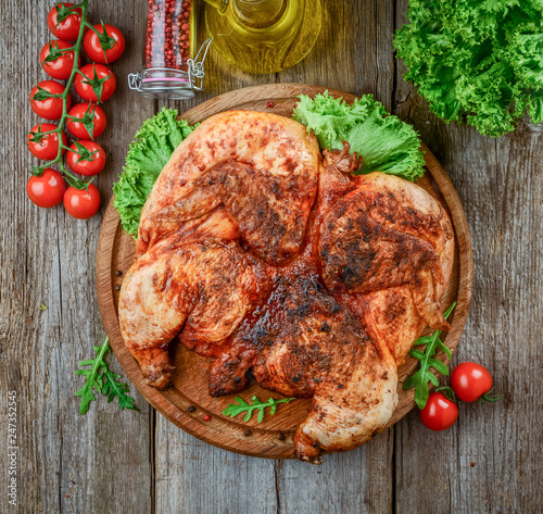 Grilled fried roast Chicken tobacco on cutting board photo