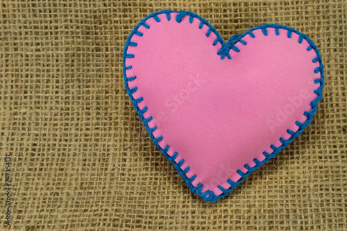 Hand stitched pink foam sheet toy heart on jute