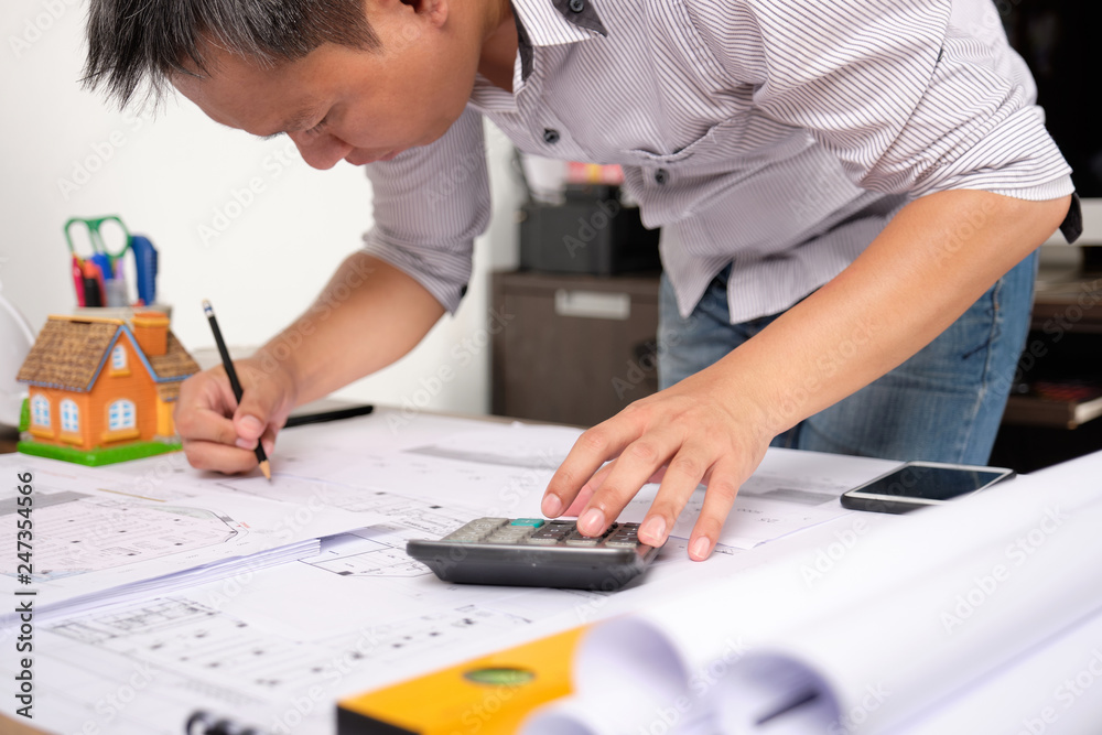 Architect is drawing construction plans on Blueprint paper with pencil. Selective Focus. Architect is drawing construction plans on Blueprint paper with pencil. Selective Focus.