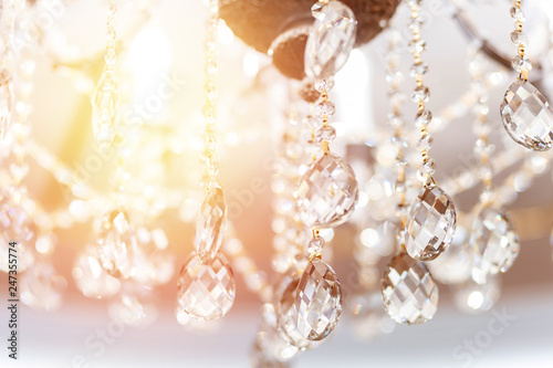 Crystal chandelier shimmers in light of close-up © Parilov