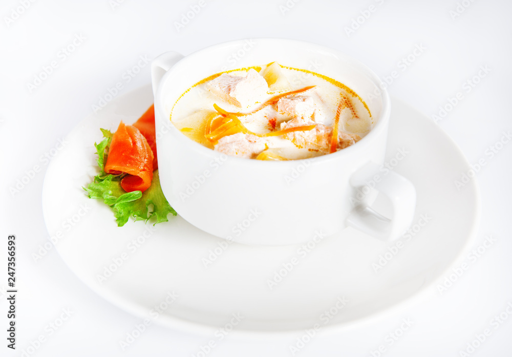 Delicious creamy soup with salmon on white Delicious creamy soup with salmon on white