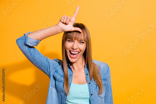 Portrait of her she nice winsome pretty lovely fascinating attractive playful cheerful straight-haired lady showing horn sign up on head isolated over bright vivid shine yellow background photo