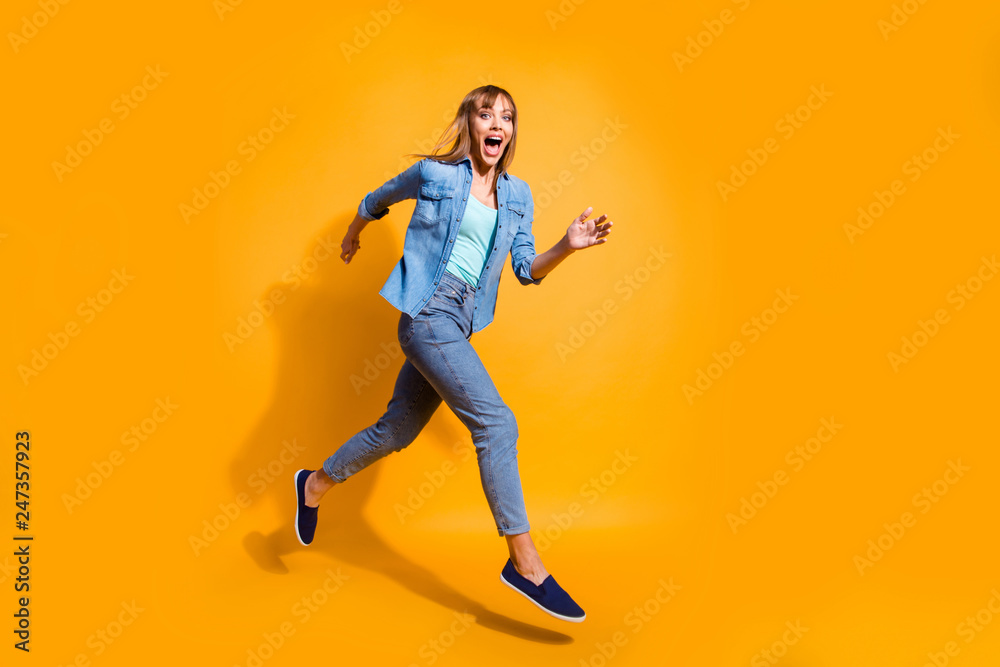 Full length body size photo yelling  jumping high amazing beautiful she her lady little low prices rushing shopping mall store wearing casual jeans denim shirt clothes isolated on yellow background