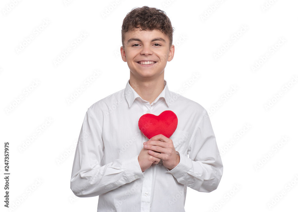 Happy Valentines Day. Cute young Teen Boy in Love with Red plush Heart in his hands. Smiling Child looking at camera, isolated on white background. Happy Valentines Day. Cute young Teen Boy in Love with Red plush Heart in his hands. Smiling Child looking at camera, isolated on white background.