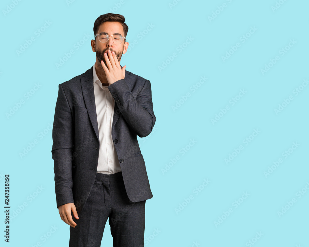 Young handsome business man tired and very sleepy Young handsome business man tired and very sleepy