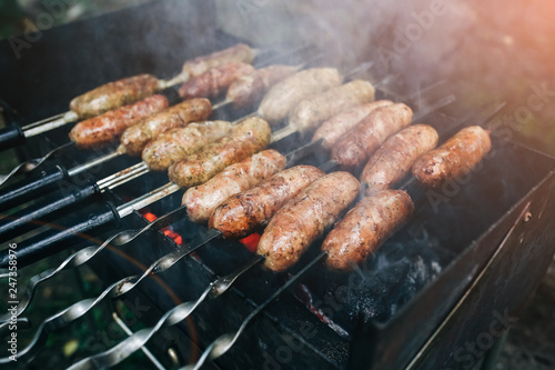 Homemade grilled sausages outdoors. Tasty food for barbecue party.