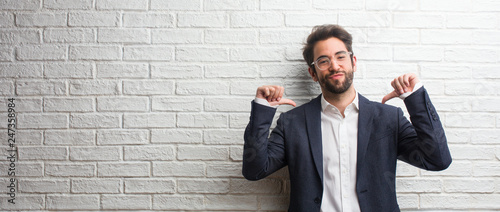 Young friendly business man proud and confident, pointing fingers, example to follow, concept of satisfaction, arrogance and health