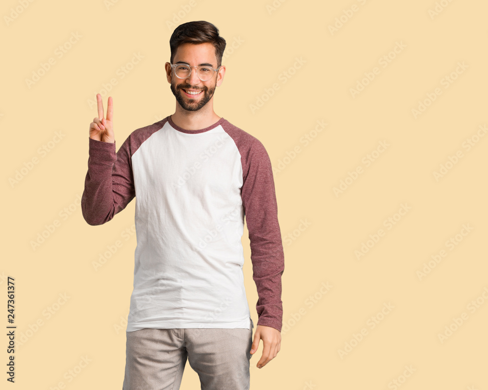 Young handsome man doing a gesture of victory Young handsome man doing a gesture of victory