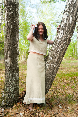 Beautiful woman on birch photo