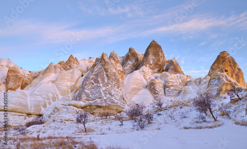 Rock formation in Cappadocia (Valley of pigeons) following a heavy snow fall. Everything covered in pure white snow under blue sky