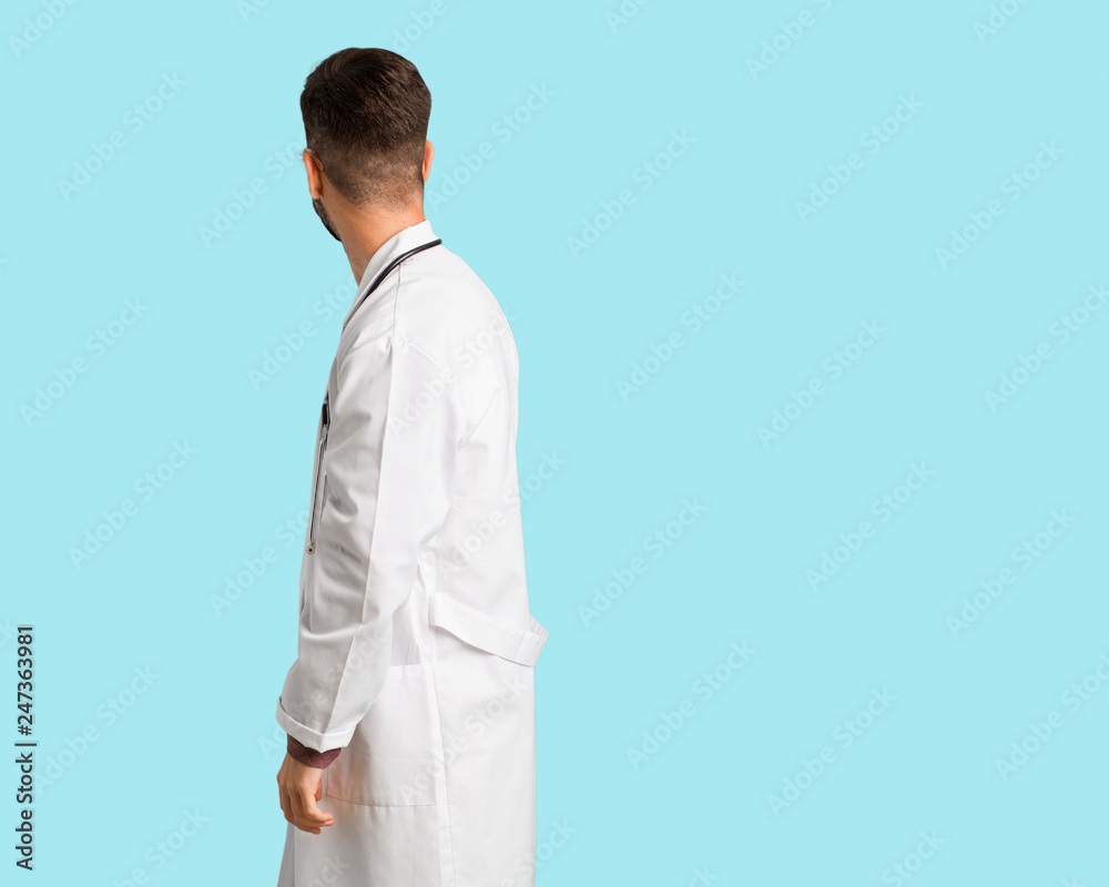 Young doctor man from behind, looking back Young doctor man from behind, looking back