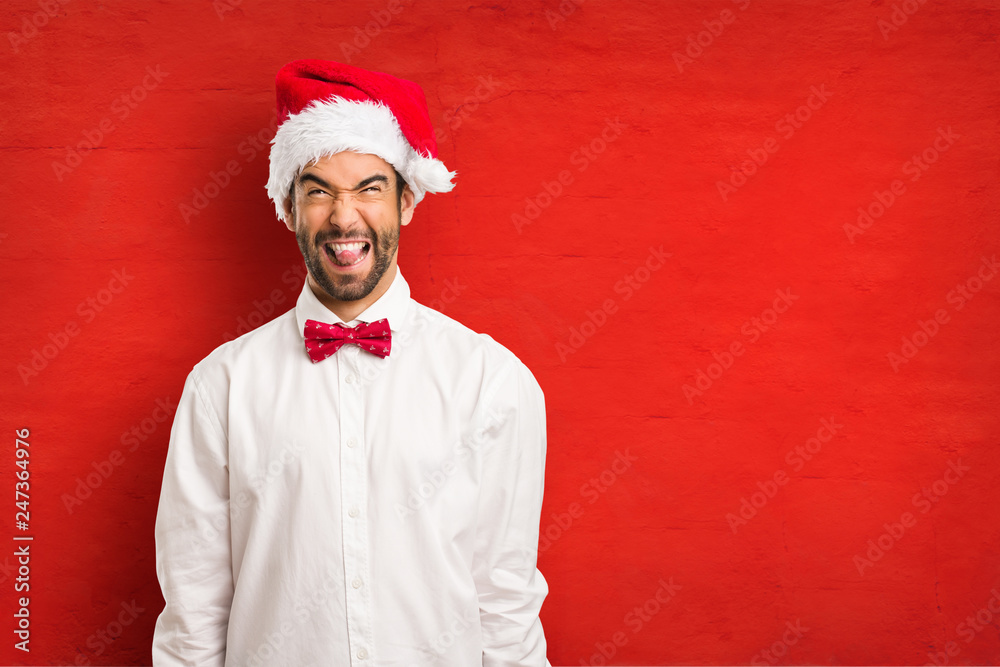 Young man wearing a santa claus hat on Christmas day Young man wearing a santa claus hat on Christmas day
