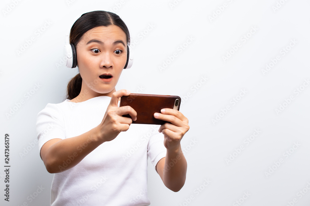 Angry woman playing to the game from smartphone Angry woman playing to the game from smartphone